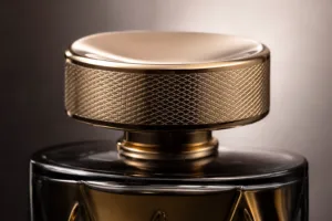 A premium studio close-up showing a decorative metal perfume cap and refined surface quality.