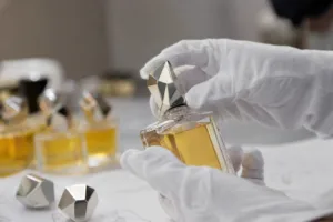 Perfume bottle cap sample being reviewed on a glass fragrance bottle for fit and finish